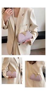 Close-up of sparkling lavender box bag with gold leaf clasp and delicate chain strap