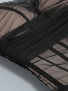 Macro shot of high-density black mesh fabric with nude lining and precise stitching details