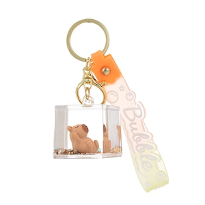 Porte-clés Capybara en acrylique avec paillettes dorées et sangle dégradée orange