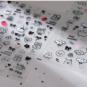 Detailed macro of gold-foil nail stickers with cartoon rabbit and heart patterns M-705