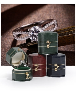 Octagonal leather jewelry boxes in dark green, wine red, and blue with gold buckles