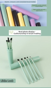 Detailed view of 5-piece makeup brush set with mint green storage barrel