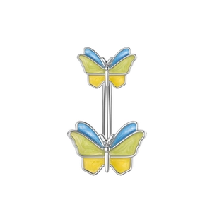 Close-up of a butterfly belly ring with blue yellow and green enamel details