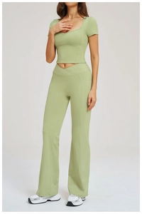 Detail of light green yoga set featuring a cross high waist flared pants and crop top