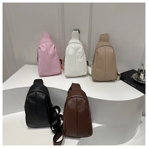 Close-up of stylish PU leather chest bags in five colors with textured finish and wide straps