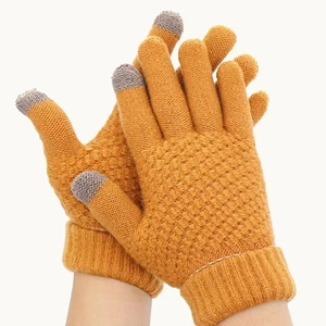 Close-up of yellow knit winter gloves with grey touchscreen-compatible fingertips on white background