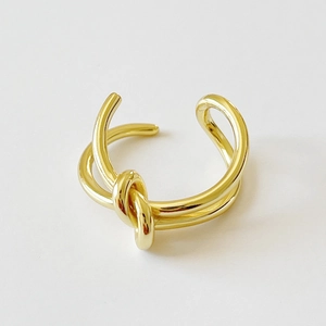 Minimalist 925 sterling silver knotted open ring in gold finish for women on white background
