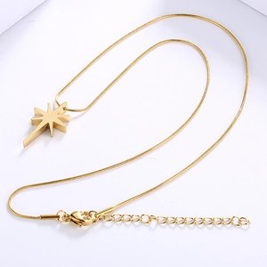 Close-up of a gold star pendant necklace with cubic zirconia and a sleek snake chain