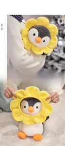 Detail of penguin plush toy with removable yellow flower headpiece and soft fur