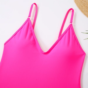 Close-up of neon pink bikini top with thin adjustable straps and deep V-neck detail