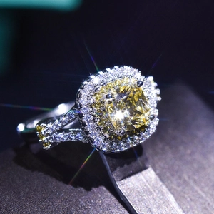 Macro view of a luxury ring featuring a radiant yellow square-cut diamond with micro-pave halo