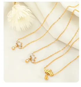 Detailed macro of gold plated necklaces with crystal zircons on soft fabric background