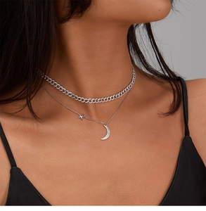 Close-up of double layer silver S925 necklace with star moon pendant and Cuban chain detail