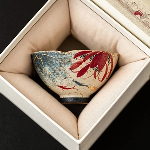 Blue and white ceramic teacup with hand-painted lotus and gold trim in a premium gift box