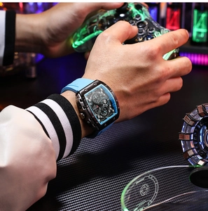 Men's blue silicone quartz watch with tonneau case shown in a modern gaming scene