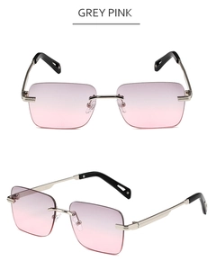 Detalle de gafas de sol cuadradas al aire con lentes degradadas gris rosa y metal