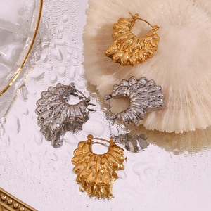 Detailed close-up of 18K gold and silver petal earrings with unique wrinkled textures