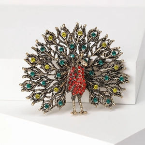 Close-up of vintage peacock brooch with colorful rhinestones and antique bronze finish