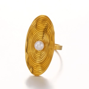 Golden oval stainless steel ring with concentric texture and pearl inlay on white background