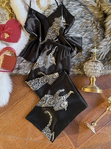 Flat lay of luxury leopard print satin pajama set with cami top and long pants