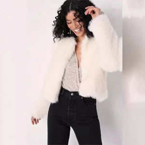 Short faux fur white jacket for women with fluffy texture over sequined top