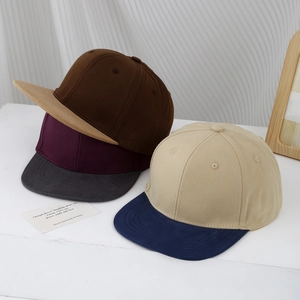 Kids vintage minimalist two-tone baseball caps in assorted colors on a textured background