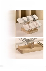 Close-up of solid wood base and cream faux leather support for jewelry display stand
