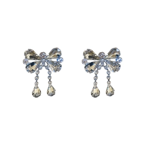 Sparkling rhinestone bow earrings with teardrop pendants on a clean white background