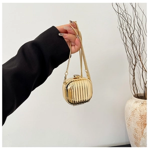 Chic gold acrylic lipstick bag with vertical stripes and delicate gold chain strap