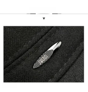 Detail showing high-quality black wool fabric and silver metal SPORTS badge on the cap