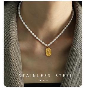 Detail of freshwater pearl necklace with gold stainless steel rose relief pendant