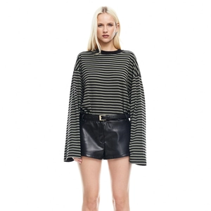 Close-up of women's green and black striped long sleeve t-shirt with slim fit crewneck