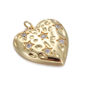 Close-up of golden heart pendant with hammered texture and five sparkling star-shaped zircons