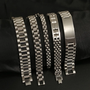 Macro detail of various silver stainless steel watch link bracelets on black velvet
