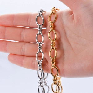 Minimalist oval linked chain bracelets in gold and silver finish shown on hand