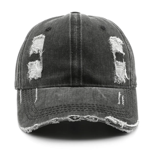Front view of a distressed dark grey washed denim baseball cap with vintage rip details