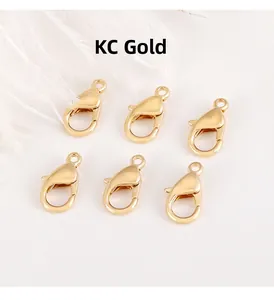 Close-up of six KC gold alloy lobster clasps for DIY jewelry making and keychains