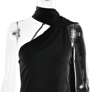 Detail of elegant black one-shoulder dress with draped fabric on transparent mannequin
