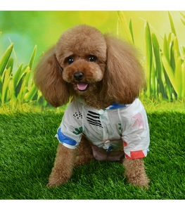 Detail of white dog summer shirt with colorful abstract geometric patterns and buttons