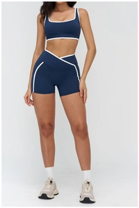 Detail of navy yoga set with square neck sports bra and contrast piping trim