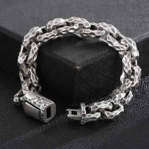 Macro shot of vintage silver steel chain bracelet with hammered texture and plug buckle