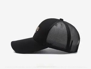 Detailed side view of black trucker hat with mesh back and golden embroidered letter S