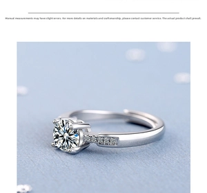 Detailed close-up of a silver ring with a four-prong set round diamond and side accents