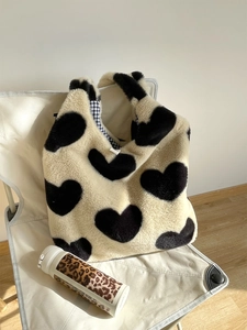 Detail of plush heart tote bag showing the soft faux fur texture and checkered blue lining