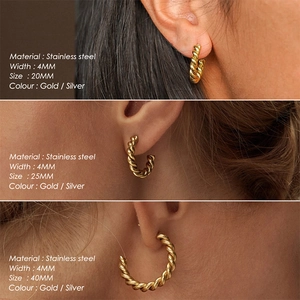 Gold plated stainless steel C-shaped twisted hoop earrings in three sizes on model