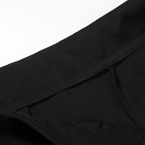 Detail of black twill fabric texture and fine stitching on high waist fashion trousers
