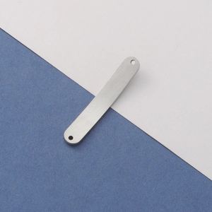 Macro view of a brushed silver titanium steel bar connector with dual holes for DIY jewelry