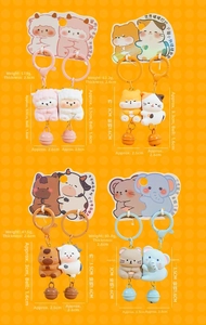 Close-up of cute magnetic resin animal keychains with metal bells and colorful backcards
