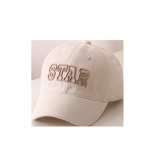 Detailed view of STAR letter embroidery and durable cotton twill on a beige baseball cap