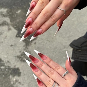 Long stiletto press on nails featuring red and black ombre with white French tips